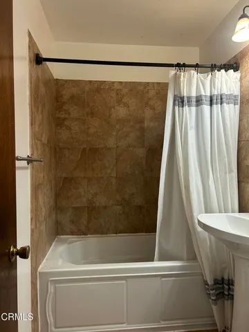 a bathroom with a shower and a tub