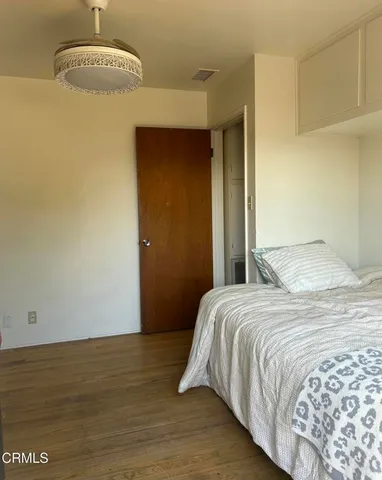 a bedroom with a bed and a mirror