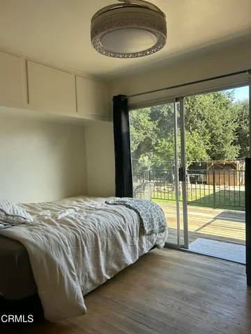 a bedroom with a bed and a large window