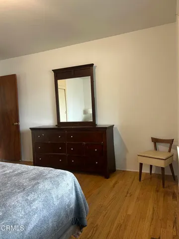 a bedroom with a bed and a dresser