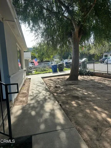 a backyard of a house with table and chairs