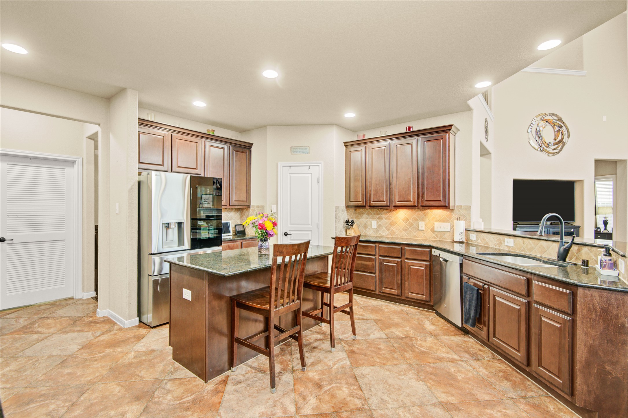 6007 Valhalla Drive Spring, TX 77379 - Photo 10 of 37 Designed for connection and entertaining, the open-concept kitchen flows seamlessly into the spacious family room.