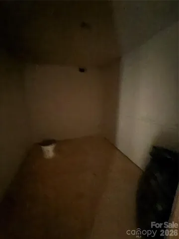 a view of a room with gym equipment and a fireplace