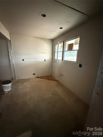 a view of a livingroom with an empty space and a window
