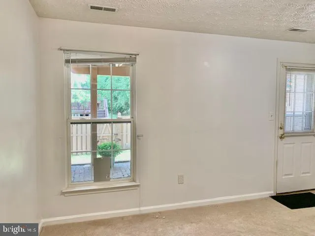 a view of a wooden door with a bench