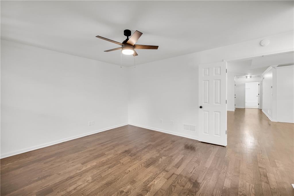 2941 Lake Hollow Road Gainesville, GA 30501 - Photo 26 of 53 an empty room with wooden floor and windows