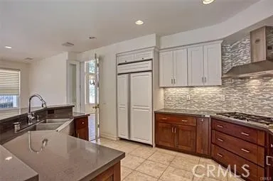 a kitchen with granite countertop a sink a stove and cabinets