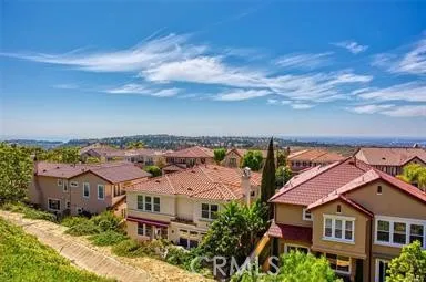 an aerial view of multiple houses with a yard
