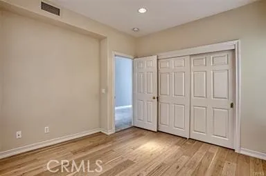 a view of an empty room and wooden floor