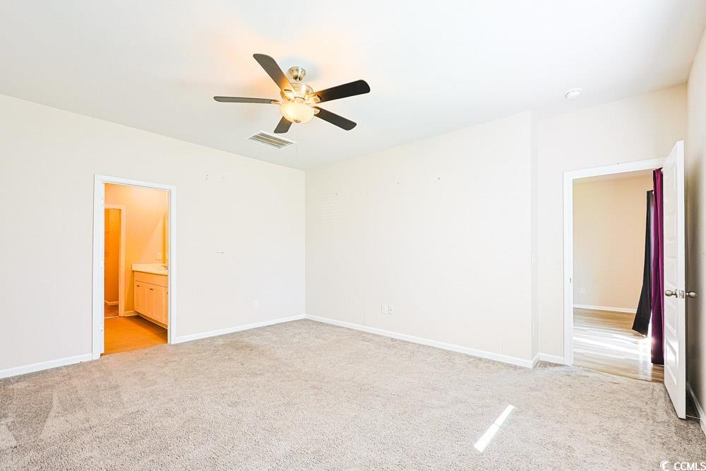 1560 Swing Bridge Way Myrtle Beach, SC 29588 - Photo 8 of 35 Unfurnished bedroom with ceiling fan, light colored carpet, and ensuite bath