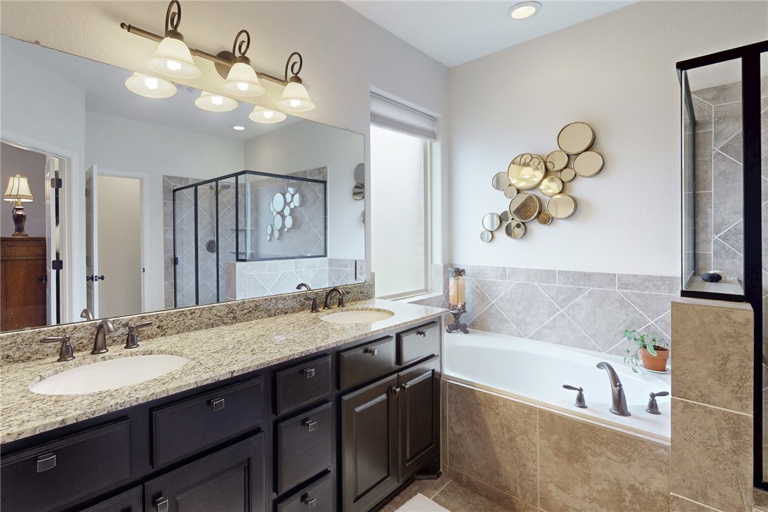 3317 Fiddlers Green Bryan, TX 77808 - Photo 21 of 39 Primary Bath Room with Dual Vanity, Granite Countertop, Tile Flooring, Separate Soaker Tub, and Separate Large Shower