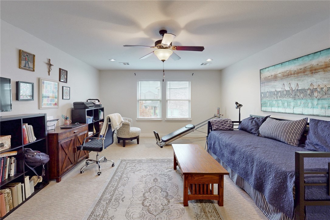 3317 Fiddlers Green Bryan, TX 77808 - Photo 27 of 36 a living room with furniture a fireplace and a large window