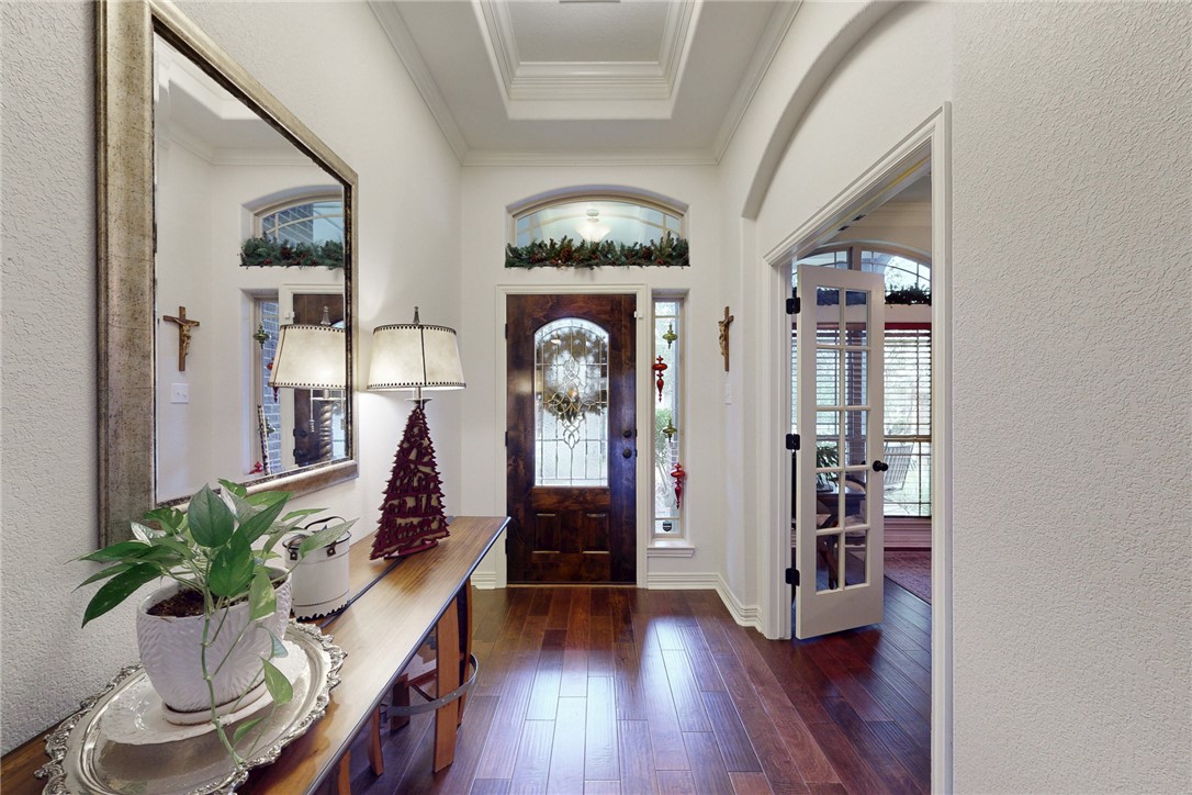 3317 Fiddlers Green Bryan, TX 77808 - Photo 6 of 39 Gorgeous Foyer with Beautiful Knotty Alder Front Door with Leaded Glass Insert, Tray Ceiling, Niche, and Transom Window