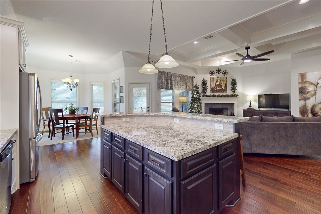3317 Fiddlers Green Bryan, TX 77808 - Photo 8 of 36 Beautiful Chef's Kitchen with Pendants and Recessed Lighting, Large Island with Food Prep and Serving Area, A Plethora of Cabinets with Soft-Close Doors and Drawers, Open into Breakfast and Family Rooms