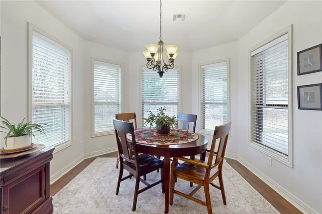 a living room with furniture and a painting on the wall