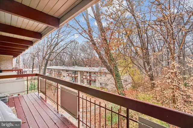 a view of balcony with wooden floor and fence