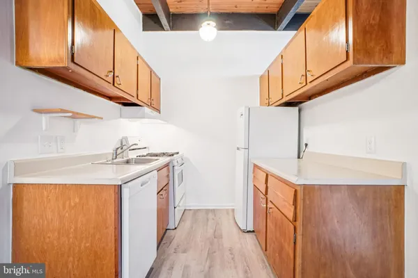 a kitchen with stainless steel appliances granite countertop a sink and dishwasher a stove top oven with wooden floor