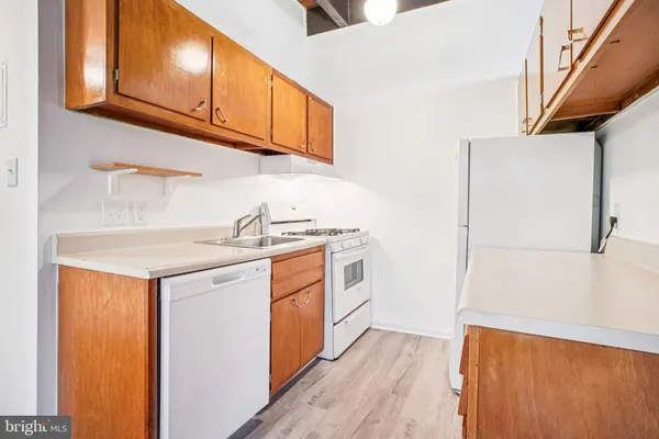a utility room with wooden floor washer and dryer
