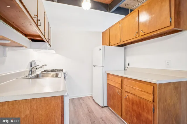 a kitchen with stainless steel appliances granite countertop a sink and dishwasher a stove top oven with wooden floor