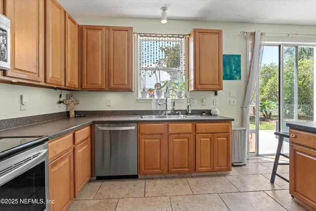 a kitchen with stainless steel appliances granite countertop a refrigerator and a stove top oven