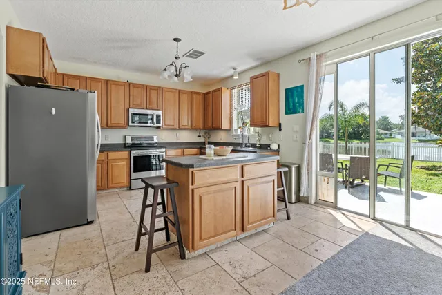 a kitchen with kitchen island white cabinets and white appliances