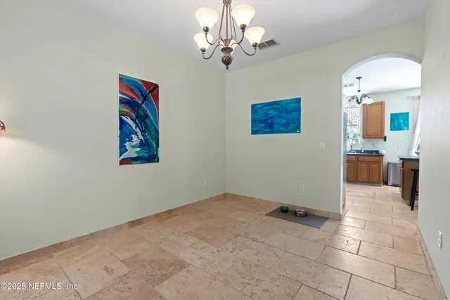 a kitchen with kitchen island granite countertop a sink cabinets and stainless steel appliances