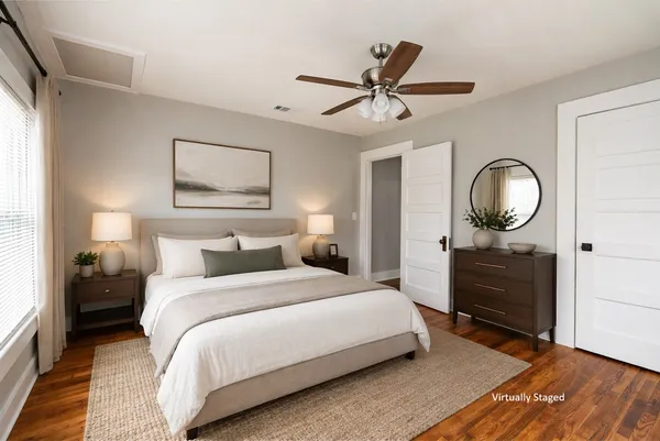 a bedroom with a bed and a mirror