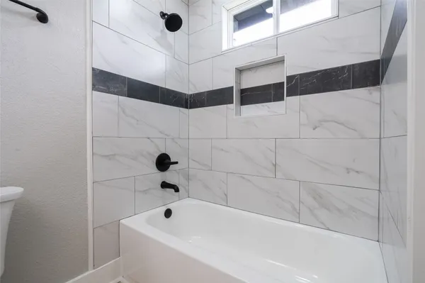 a bathroom with a bathtub and shower