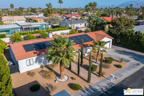 an aerial view of a house with swimming pool patio and outdoor seating