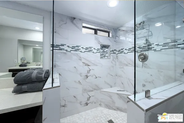 a bedroom with a bed and wall painting on the wall