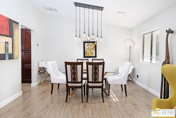 a view of a dining room with furniture and wooden floor