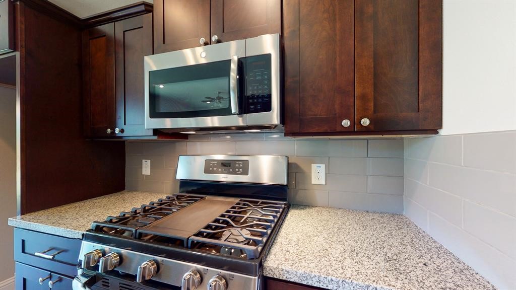 311 Mascot Street Houston, TX 77029 - Photo 13 of 23 a kitchen with a stove and a microwave