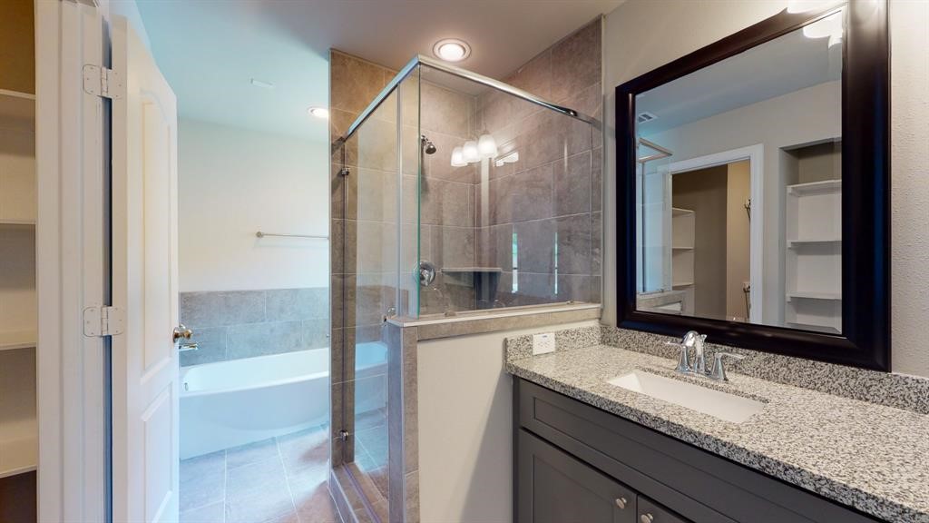 311 Mascot Street Houston, TX 77029 - Photo 17 of 23 a bathroom with a granite countertop sink and a mirror