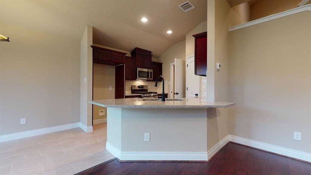 311 Mascot Street Houston, TX 77029 - Photo 6 of 23 a kitchen with stainless steel appliances a sink stove and cabinets