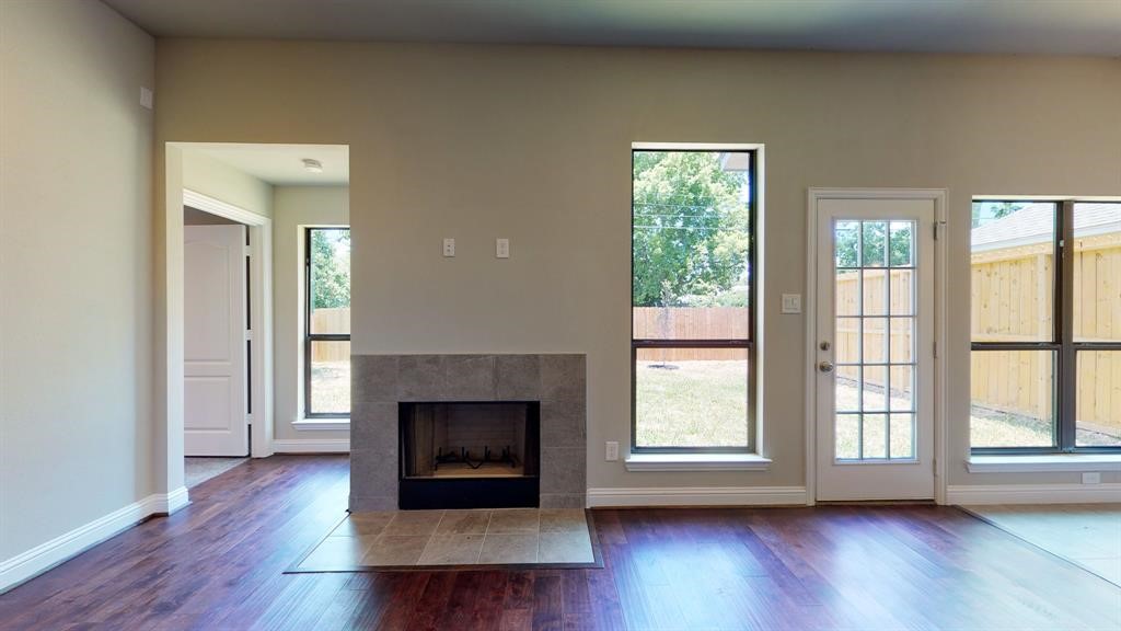 311 Mascot Street Houston, TX 77029 - Photo 10 of 23 a view of a livingroom with a fireplace wooden floor and window