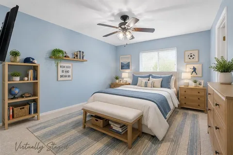 a bedroom with a bed and a chandelier