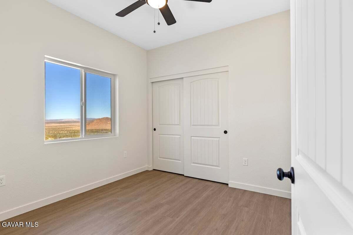 10654 Wilson Road California City, CA 93505 - Photo 13 of 36 a view of an empty room with wooden floor and a window