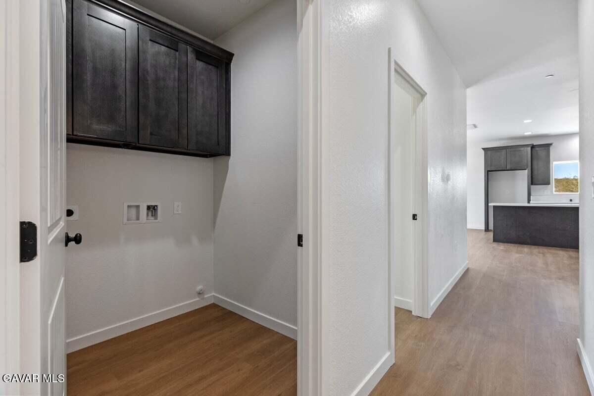 10654 Wilson Road California City, CA 93505 - Photo 19 of 36 a view of a hallway with wooden floor and staircase