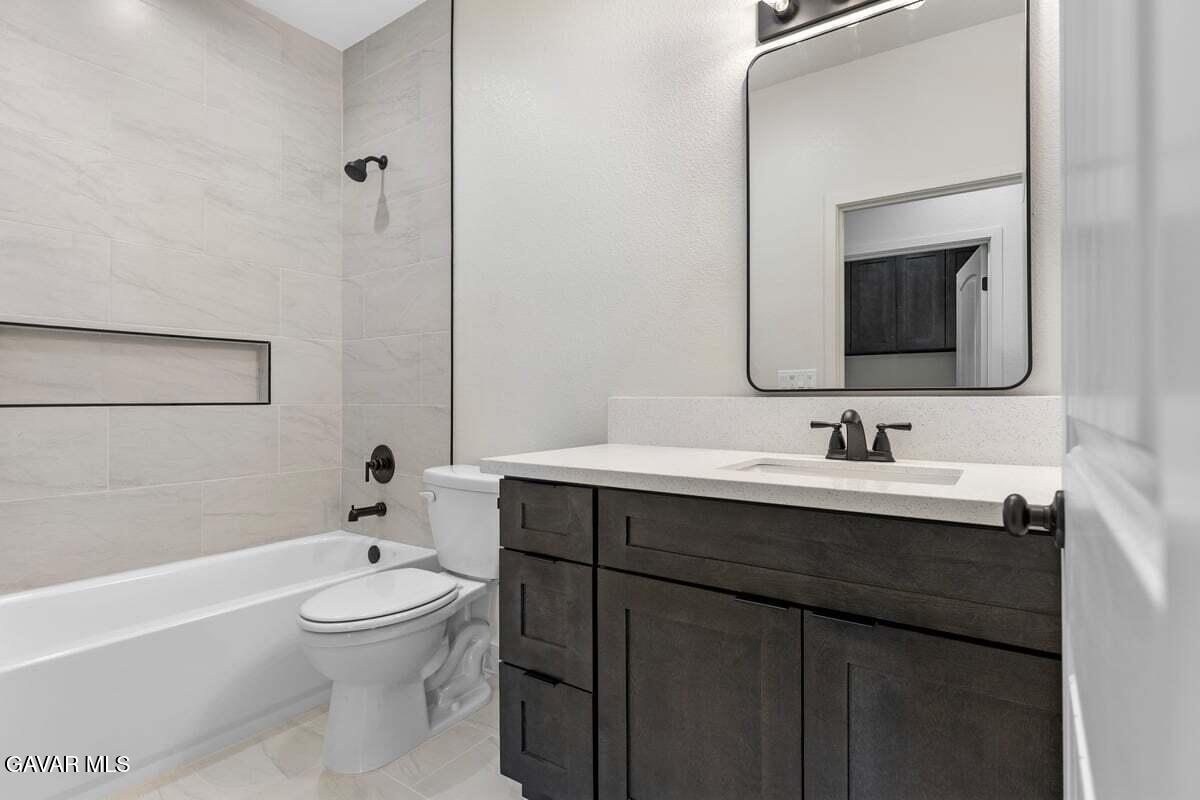 10654 Wilson Road California City, CA 93505 - Photo 20 of 36 a bathroom with a toilet a sink a bathtub and mirror