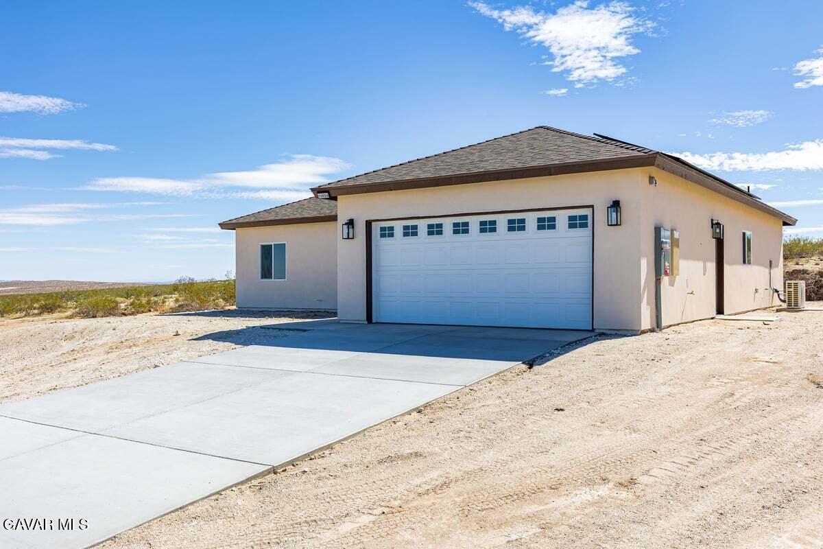 10654 Wilson Road California City, CA 93505 - Photo 2 of 36 a front view of a house with a yard and ocean