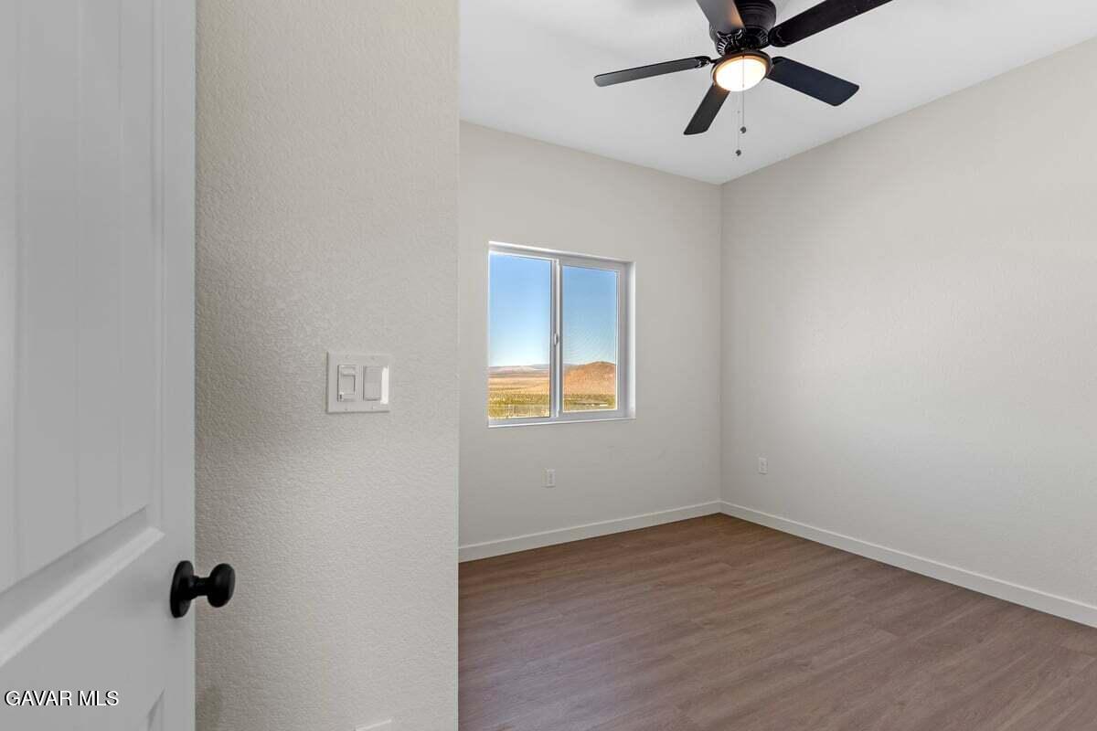 10654 Wilson Road California City, CA 93505 - Photo 23 of 36 an empty room with a window and a ceiling fan