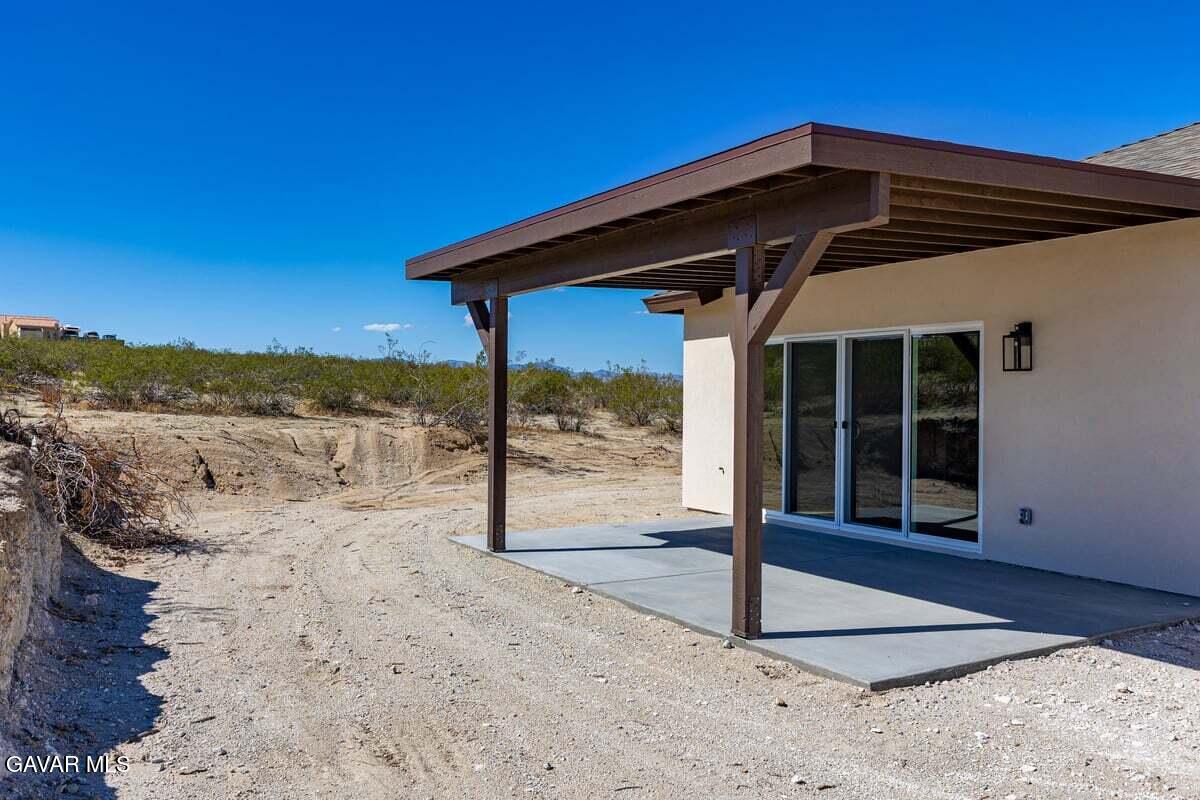 10654 Wilson Road California City, CA 93505 - Photo 29 of 36 a black and white house with a outdoor space