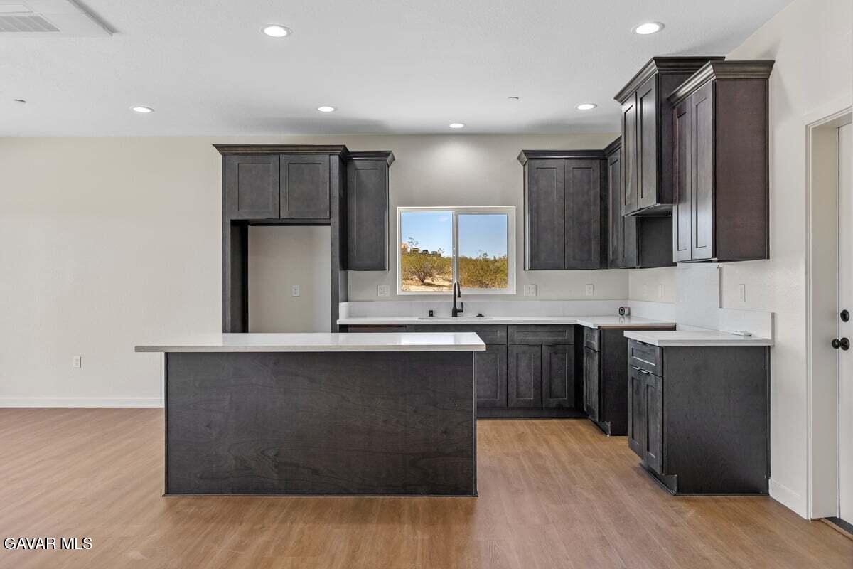 10654 Wilson Road California City, CA 93505 - Photo 6 of 36 a kitchen with stainless steel appliances granite countertop a sink stove and refrigerator