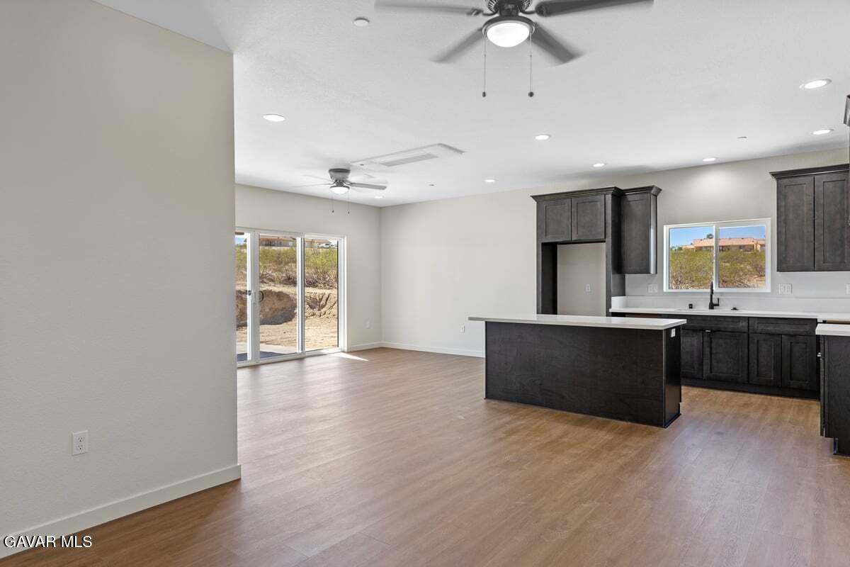 10654 Wilson Road California City, CA 93505 - Photo 7 of 36 a large kitchen with stainless steel appliances a large counter top a sink a refrigerator and a window