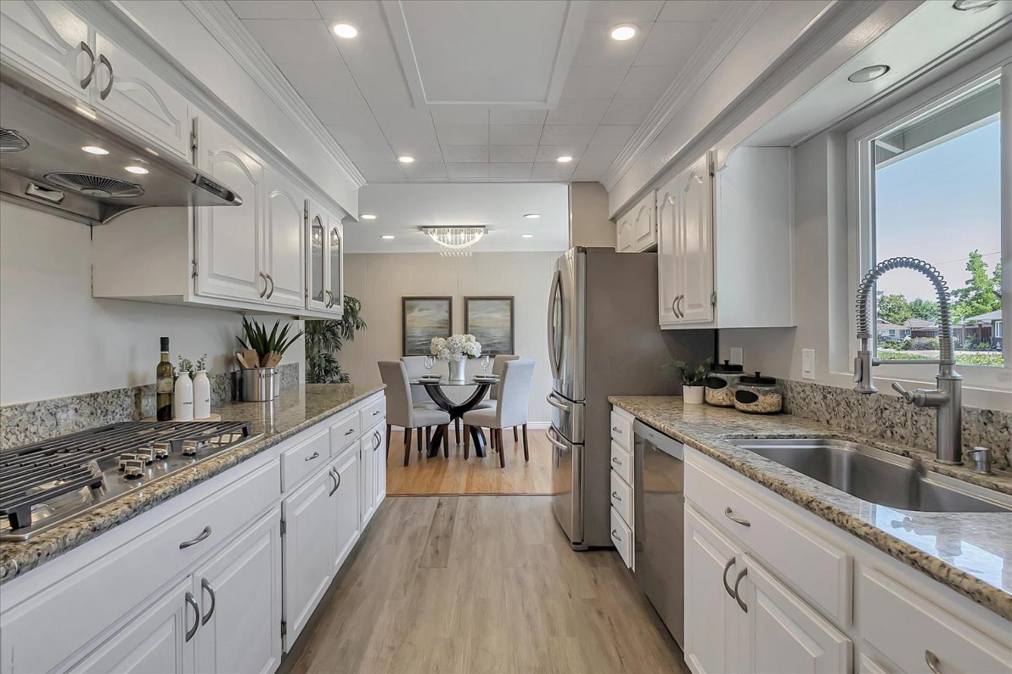 1963 Geneva Street San Jose, CA 95124 - Photo 12 of 35 a kitchen with lot of cabinets a sink a window and stainless steel appliances