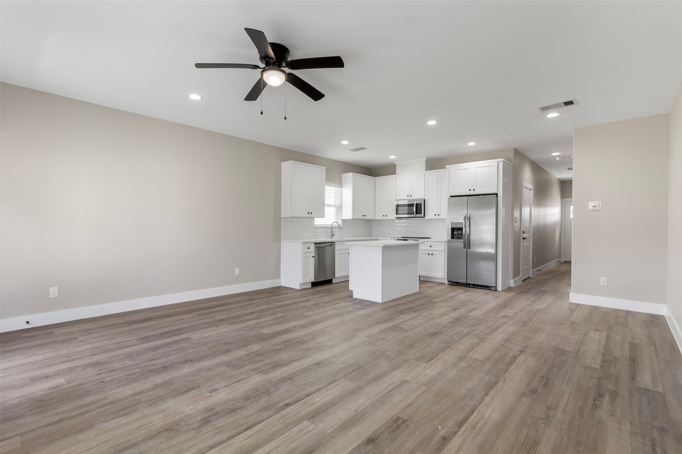 3150 South Cleveland Street Dayton, TX 77535 - Photo 5 of 24 a view of kitchen with stainless steel appliances refrigerator stove microwave and cabinets