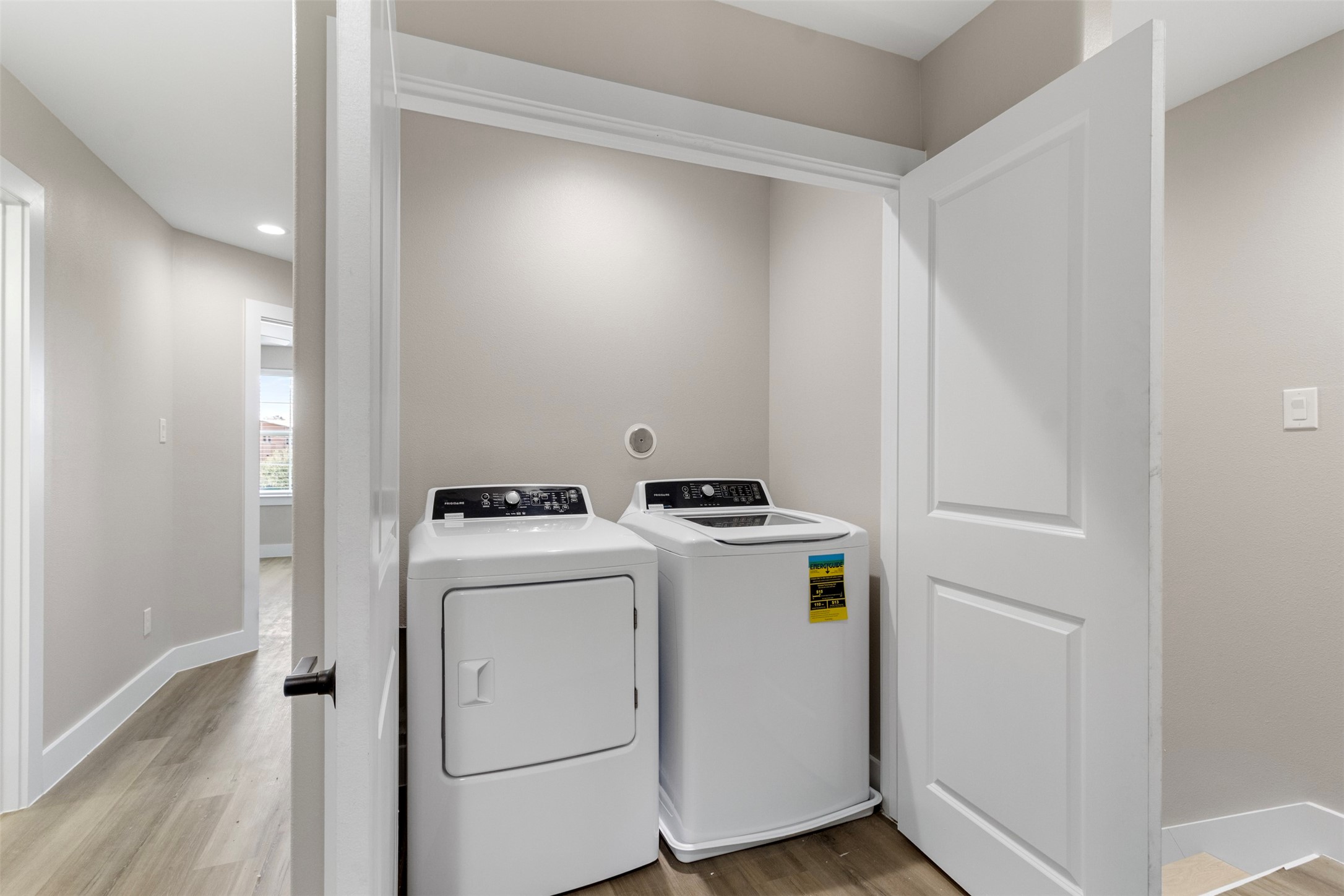 3150 South Cleveland Street Dayton, TX 77535 - Photo 7 of 24 a view of washer and dryer with wooden floor