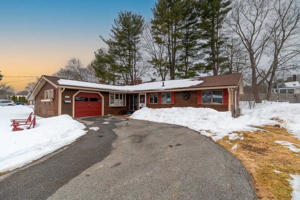 a front view of a house with a yard covered in snow