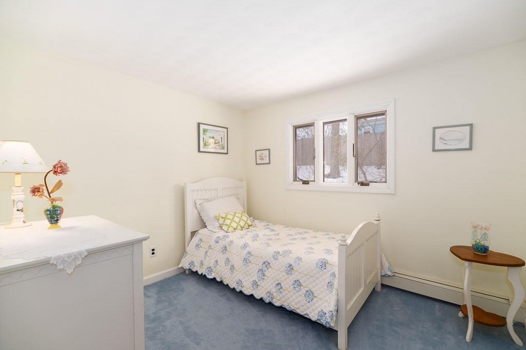 14 Grove Street Danvers, MA 01923 - Photo 12 of 23 a bedroom with a bed and a table in it