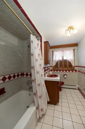 a bathroom with a tub sink and mirror